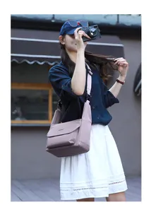 Minimalist crossbody shoulder bag detail, elegant mauve hue, casual daily commuter style.