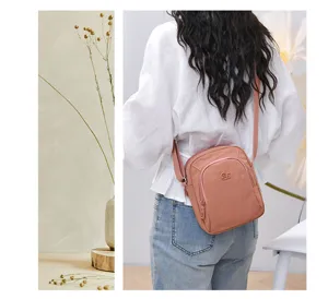 Detailed view of the women's nylon crossbody bag, showcasing multi-layer design and back wear style.