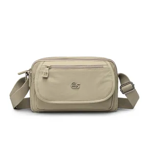 Casual nylon crossbody bag with multi-layer zipper compartments and adjustable strap for women.