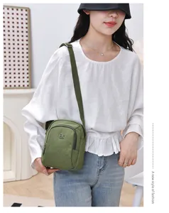 Minimalist green nylon crossbody bag for women, casual multi-layer shoulder daily handbag.