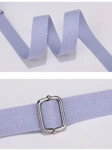 Nylon bag strap detail close up, durable woven fabric with silver metal adjuster buckle accessory.
