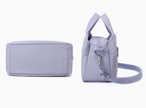 Detailed view of the multi-compartment nylon handbag showing bottom structure and side strap.