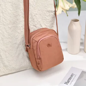 Casual nylon crossbody bag for women, multi-layer shoulder bag with simple daily design.