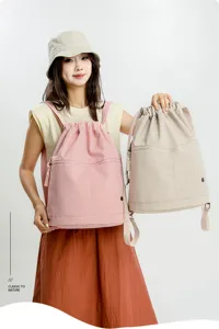 Detailed view of lightweight nylon drawstring backpack in stylish pink and beige colors for gym.