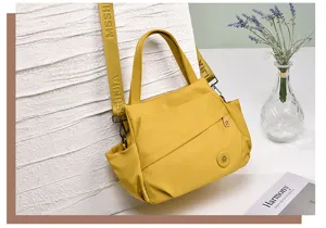 Yellow nylon casual shoulder bag with stylish strap, spacious design for daily use.