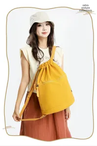 Detail view of the yellow drawstring backpack worn by model, showing casual everyday style.