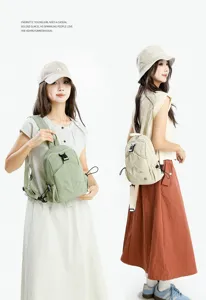 Detail view of casual oxford backpack showing adjustable straps and front pocket design.