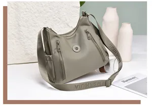 Lightweight waterproof nylon crossbody shoulder bag for women commuting, casual daily use.