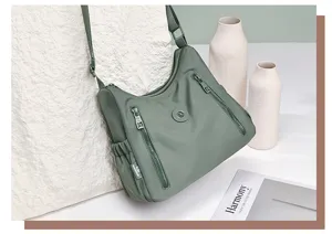 Nylon crossbody shoulder bag detail, casual daily waterproof handbag with multiple zip pockets.