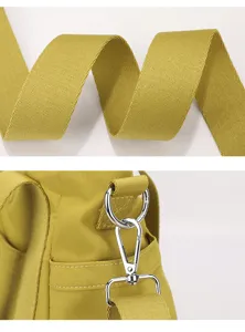 Oxford cloth shoulder bag detail showcasing durable woven strap and premium silver metal hardware.