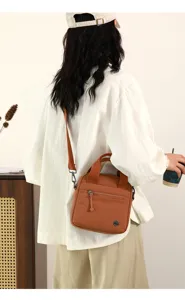 Casual canvas crossbody bag for women, lightweight shoulder bag with handy front zip pocket.