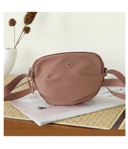 Minimalist solid color nylon crossbody bag detail view, casual mini shoulder bag for women.