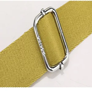 Close-up detail shot of the durable metal buckle and woven strap on a stylish everyday bag.