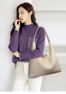 Close-up view of the minimalist hobo shoulder bag styled elegantly with casual wear.