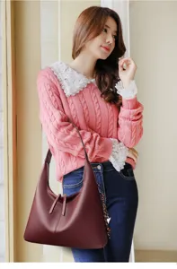 Wine red leather shoulder bag detail, elegant hobo style, premium daily fashion accessory.