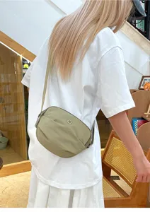 Casual nylon crossbody bag for women, lightweight solid color shoulder crescent purse detail.