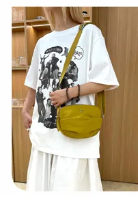 Detail view of a stylish yellow crossbody bag with gathered design, perfect for daily casual wear.