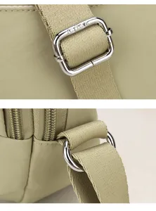 Detail close-up view of women nylon shoulder bag strap buckle and metal rings for casual daily use.