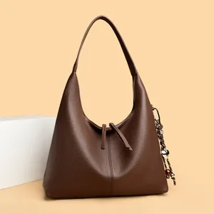 Stylish brown leather hobo shoulder bag for women, premium commuter tote bag with chic charm.