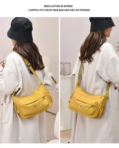 Detailed view of stylish yellow nylon crossbody shoulder bag with multi pockets and adjustable strap.