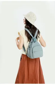Detail view of the stylish light blue casual multi-functional backpack worn by model.
