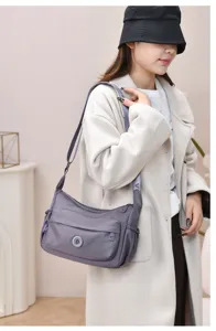 Multifunctional nylon shoulder bag for women, casual crossbody tote with zipper pockets.