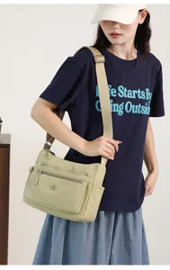 Nylon crossbody bag for women, lightweight casual shoulder bag with multiple zippered pockets.