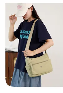 Detail shot of the casual shoulder bag showcasing multi-pocket design and adjustable strap.
