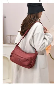 Detail view of the versatile wine red nylon shoulder crossbody hobo bag for daily casual wear.