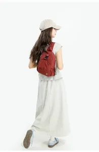 Casual mini backpack for women, lightweight nylon travel daypack, stylish red small schoolbag.