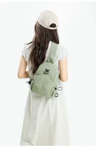 Lightweight women casual mini backpack in light green nylon with secure functional zipper pockets.