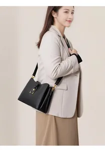 Detailed view of the elegant black leather shoulder bag with chic gold hardware and rose clasp.