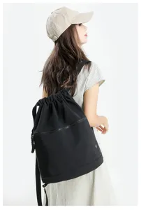 Black drawstring backpack for women, lightweight nylon large capacity casual sports gym daypack.
