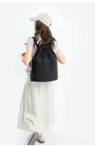 Women's solid color lightweight drawstring backpack large capacity casual sports gym bag.