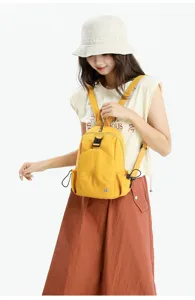 Detailed view of women casual yellow backpack, lightweight oxford cloth travel daypack.