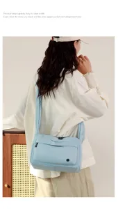 Detail view of the light blue nylon crossbody bag, showcasing practical large capacity design.