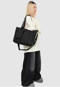Black multi-compartment women work tote bag with insulated cooler lunch compartment detail.