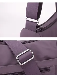 Detailed close-up view of purple nylon crossbody bag strap, durable metal hardware buckle.