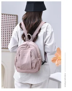 Zaino casual rosa elegante in tela per viaggi all'aperto e uso scolastico quotidiano.