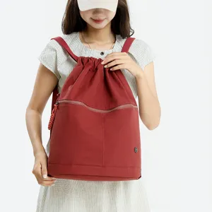 Women nylon drawstring backpack casual sports gym daypack with front zipper pocket.