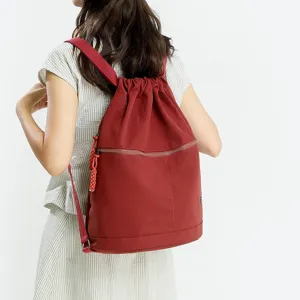 Red drawstring backpack for women, large capacity casual sports gym daypack with zipper pocket.