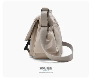 Side view detail of the minimalist casual waterproof nylon messenger crossbody bag.