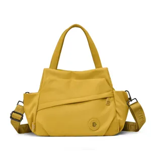 Yellow nylon tote bag for women, stylish shoulder crossbody bag with top handles and strap.