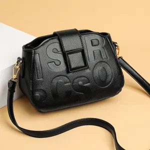 Stylish women black leather shoulder crossbody bag featuring embossed letters and square buckle.