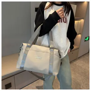 Large capacity multi-functional travel duffel bag with waterproof fabric and shoulder strap.