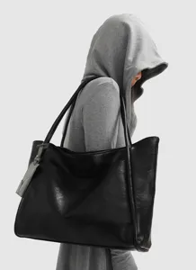 Detailed view of the stylish black large capacity womens shoulder tote bag side profile.