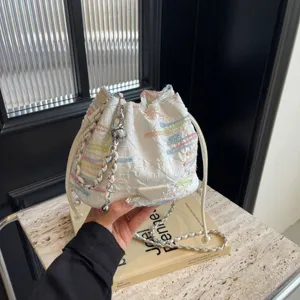 Fashionable Chinese style quilted bucket bag with colorful embroidery and chain strap for summer.