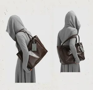 Detailed view of large brown leather tote bag with double straps and minimalist style.