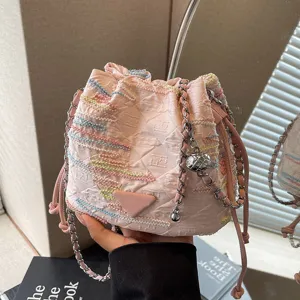 Stylish pink nylon bucket bag with colorful embroidery and chain strap for women summer daily wear.