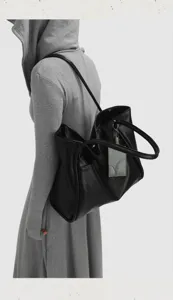 Detail view of black shoulder tote bag showing large capacity and minimalist design.